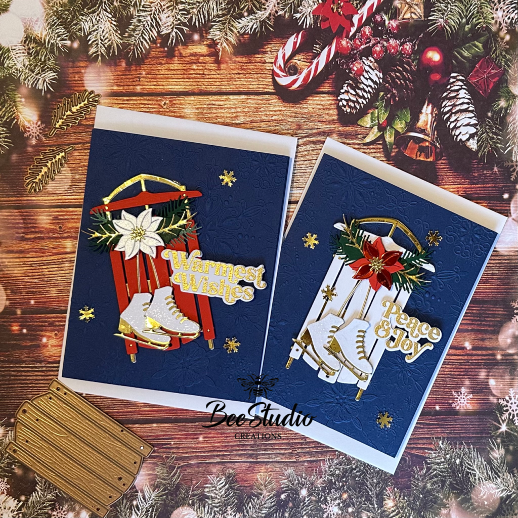 2 completed cards with dark blue backgrounds, sledge, ice skates and poinsettia. 