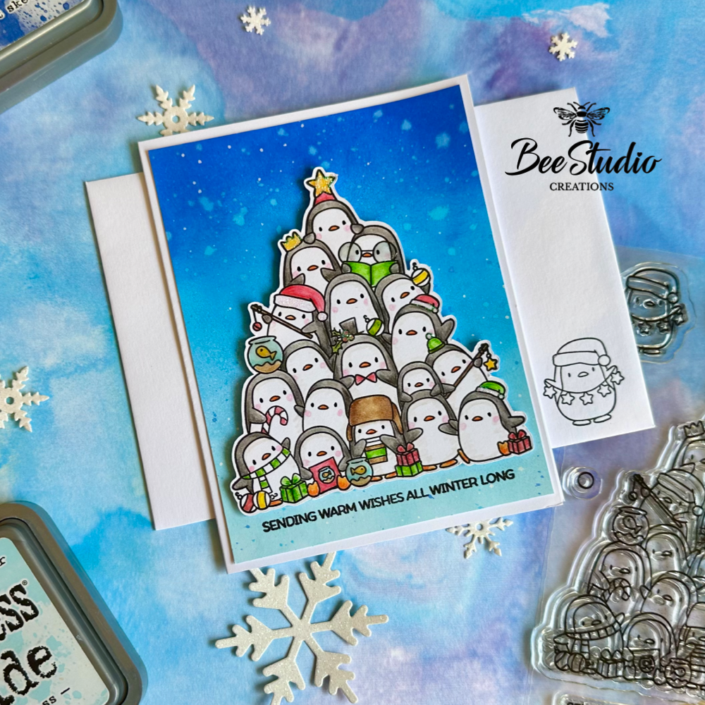 Finished xmas card with tree shaped stack of penguins. 